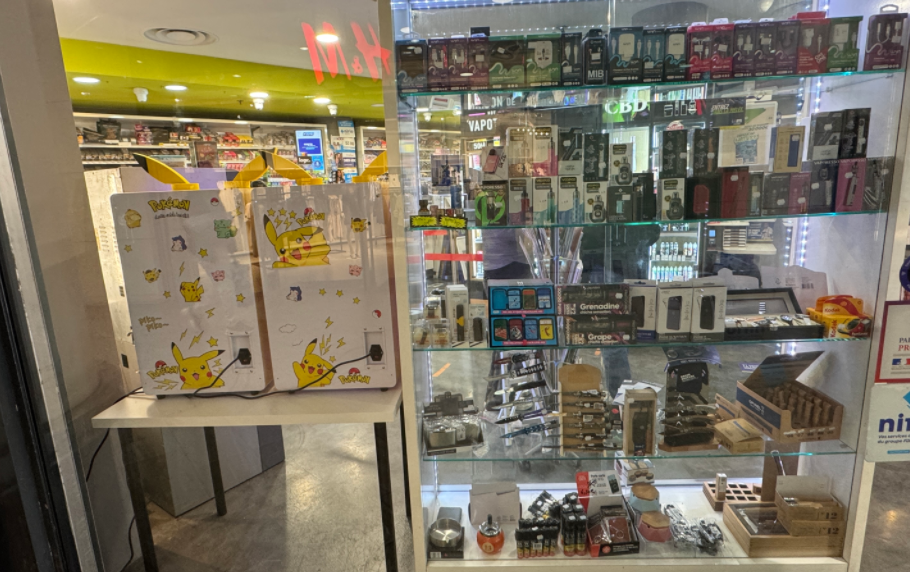 customers checking pokemon vending machine in French shop