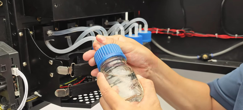 Operator refilling fragrance liquid inside a perfume vending machine tank