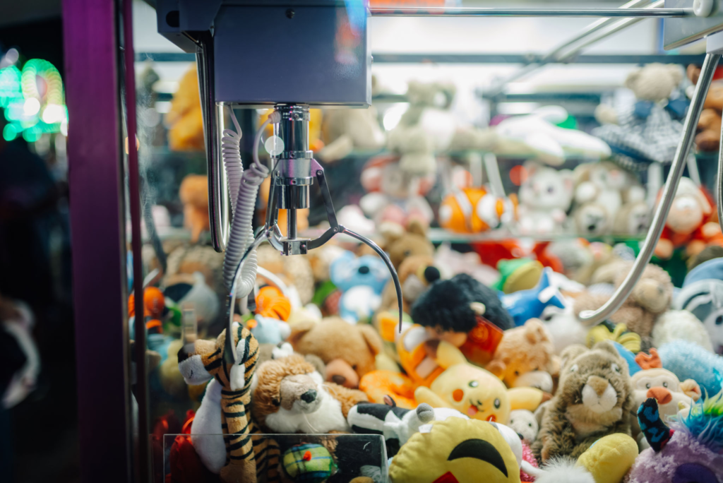 claw machine grabbing plush toys
